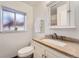 Cozy bathroom with a travertine vanity top, tiled floors, and a convenient medicine cabinet at 16333 E Carolina Dr, Aurora, CO 80017