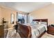 Comfortable bedroom features soft carpet, a modern window, and a stately wooden bed frame at 16333 E Carolina Dr, Aurora, CO 80017
