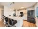 Modern eat-in kitchen featuring an island with bar seating, stainless appliances and hardwood floors at 16333 E Carolina Dr, Aurora, CO 80017