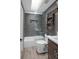 Modern bathroom features shower over tub, sleek tiling, and industrial-style shelving at 8764 W 95Th Ave, Broomfield, CO 80021
