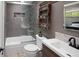 Well-lit bathroom with shower over tub and industrial-style shelving at 8764 W 95Th Ave, Broomfield, CO 80021