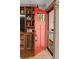 Inviting entryway featuring a red front door, rustic wood built-ins, and hardwood floors at 8764 W 95Th Ave, Broomfield, CO 80021