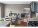 Kitchen with stainless appliances, stone countertops, hardwood floors, and open concept to the dining area at 8764 W 95Th Ave, Broomfield, CO 80021