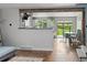 Bright kitchen and dining area with white cabinets, stainless steel appliances, and sliding glass doors to the backyard at 8764 W 95Th Ave, Broomfield, CO 80021