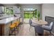 Open concept kitchen and dining area with patio access, modern countertops, stainless appliances, and wood accents at 8764 W 95Th Ave, Broomfield, CO 80021