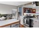 Updated kitchen features stainless appliances, stone countertops, gray cabinets, and an open concept to the living areas at 8764 W 95Th Ave, Broomfield, CO 80021