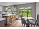 Inviting kitchen and dining space with light countertops, modern stools, and a view of the backyard at 8764 W 95Th Ave, Broomfield, CO 80021