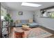 Bright living room featuring a skylight, comfortable seating, and a view into the kitchen at 8764 W 95Th Ave, Broomfield, CO 80021