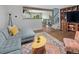 Spacious living room with hardwood floors, comfortable seating, and easy access to the kitchen and staircase at 8764 W 95Th Ave, Broomfield, CO 80021