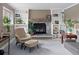 Cozy living room with a stone fireplace, built-in shelves, comfortable seating and lovely decor at 8764 W 95Th Ave, Broomfield, CO 80021