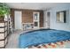Comfortable bedroom with wood accent wall, ample storage and an ensuite bathroom at 8764 W 95Th Ave, Broomfield, CO 80021