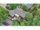 An aerial view showcasing a home's roof, backyard deck with pergola, and mature trees at 1746 Shavano St, Longmont, CO 80504