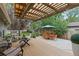 Outdoor living space featuring a covered patio, a well-manicured lawn, and dining area at 1746 Shavano St, Longmont, CO 80504