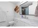 Modern bathroom featuring marble countertop, hexagon shelves, and paneled walls at 1746 Shavano St, Longmont, CO 80504