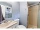 A bathroom featuring a shower, toilet, and a sink with mirror at 1746 Shavano St, Longmont, CO 80504