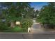 A single story home with a brick facade, a well-manicured lawn, and mature trees at dusk at 1746 Shavano St, Longmont, CO 80504