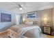 Light-filled bedroom featuring a king bed, nightstands, and a ceiling fan at 1746 Shavano St, Longmont, CO 80504