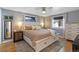 Serene main bedroom with hardwood floors, a ceiling fan, neutral paint, and good natural light at 1746 Shavano St, Longmont, CO 80504