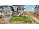Backyard with a small lawn, surrounded by wooden fences, and steps to an elevated deck at 17843 W 93Rd Pl, Arvada, CO 80007