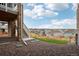 View of the backyard with gravel and a set of steps leading to a second-story deck at 17843 W 93Rd Pl, Arvada, CO 80007