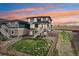 Charming two-story home with a stone and gray exterior and a well-maintained lawn at 17843 W 93Rd Pl, Arvada, CO 80007