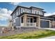 Beautiful two-story home featuring stone accents, a covered porch, and an attached two-car garage at 17843 W 93Rd Pl, Arvada, CO 80007