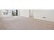 A spacious living room boasts neutral carpeting and offers seamless access to the exterior at 17843 W 93Rd Pl, Arvada, CO 80007