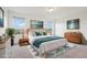 A bright and airy primary bedroom featuring stylish decor, soft carpeting, and ample natural light at 17843 W 93Rd Pl, Arvada, CO 80007