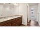 Elegant bathroom features a double vanity with stone countertops, providing ample space and style at 17843 W 93Rd Pl, Arvada, CO 80007