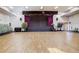 Large auditorium with a stage, ample seating, and a polished wooden floor, perfect for various events at 580 S Clinton St # 12C, Denver, CO 80247