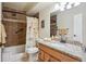 Cozy bathroom featuring tiled walls, a shower-tub combination, and granite countertops at 580 S Clinton St # 12C, Denver, CO 80247