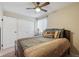 Well-lit bedroom with ceiling fan, large window, and closet, offering comfort and convenience at 580 S Clinton St # 12C, Denver, CO 80247