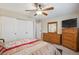 Bright bedroom with large closet, dresser, and modern ceiling fan at 580 S Clinton St # 12C, Denver, CO 80247