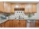 Modern kitchen with granite countertops, stainless steel appliances, and tile backsplash at 580 S Clinton St # 12C, Denver, CO 80247