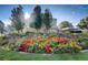 Landscaped circular flowerbed with bright colorful plants and a water feature at 580 S Clinton St # 12C, Denver, CO 80247