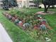 A flower bed is landscaped with a variety of plants and shrubbery along the grass at 580 S Clinton St # 12C, Denver, CO 80247