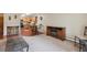 Cozy living room featuring carpet, a fireplace, and seamless flow into the kitchen at 580 S Clinton St # 12C, Denver, CO 80247