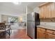 Open-concept living area with kitchen view and balcony access at 580 S Clinton St # 12C, Denver, CO 80247