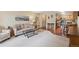 Comfortable living area featuring a sofa, coffee table, and mountain-themed artwork at 580 S Clinton St # 12C, Denver, CO 80247