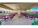 Outdoor dining space with metal tables and chairs under a covered area at 580 S Clinton St # 12C, Denver, CO 80247