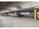 Well-lit parking garage featuring assigned parking spots and secure storage units at 580 S Clinton St # 12C, Denver, CO 80247