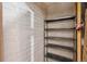 Spacious storage with brick walls and metal shelving, ideal for organizing belongings at 580 S Clinton St # 12C, Denver, CO 80247