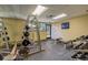 Weight room featuring various machines, free weights, and mirrors for effective strength training at 580 S Clinton St # 12C, Denver, CO 80247