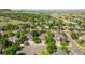This aerial view showcases a neighborhood with well-maintained homes, mature trees, and green spaces at 10565 Kalahari Ct, Lone Tree, CO 80124