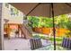 This home features a large backyard with a patio, stairs to the upper deck, a grill, and a privacy fence at 10565 Kalahari Ct, Lone Tree, CO 80124