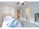 Brightly-lit bedroom featuring a twin bed, neutral carpeting, and doors to the hallway and bath at 10565 Kalahari Ct, Lone Tree, CO 80124