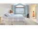 Comfortable bedroom with blue walls and large window at 10565 Kalahari Ct, Lone Tree, CO 80124