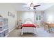 Bedroom featuring a single bed, a window with patterned curtains, a wooden rocking chair, and a desk at 10565 Kalahari Ct, Lone Tree, CO 80124