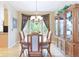 Bright dining room with large windows, hardwood floors, and elegant chandelier at 10565 Kalahari Ct, Lone Tree, CO 80124