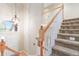 Inviting entryway featuring a staircase, chandelier, and view of the front door at 10565 Kalahari Ct, Lone Tree, CO 80124